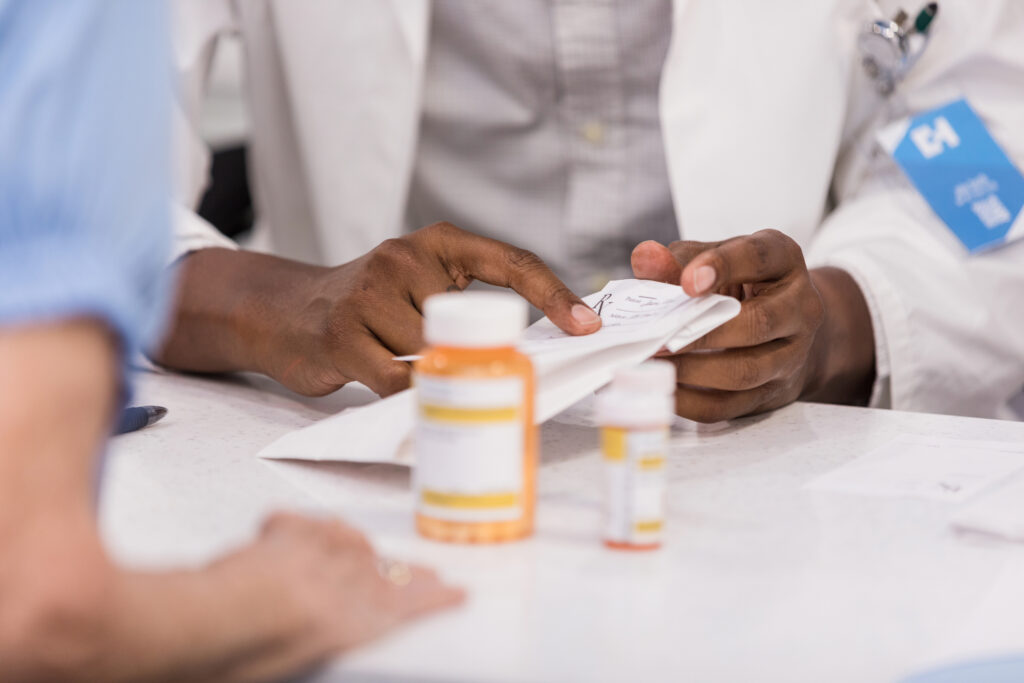 Unrecognizeable people at the pharmacy counter