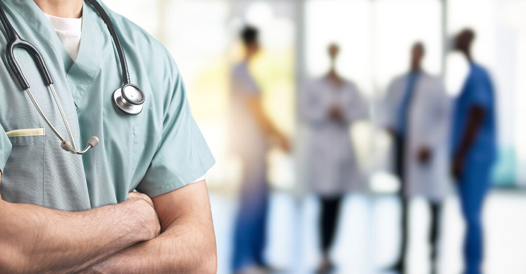 A,Close-up,Of,A,Healthcare,Professional,In,Scrubs,With,Arms